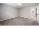 Bedroom featuring a ceiling fan, carpet, and ensuite access to a bathroom at 1903 Malone Rd # E, Burlington, NC 27215