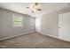 Bright bedroom with neutral paint, ceiling fan, carpet, and natural light from the multiple windows at 1903 Malone Rd # E, Burlington, NC 27215