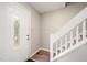 Inviting entryway featuring a decorative glass door, wood floors, and a staircase with white railings at 1903 Malone Rd # E, Burlington, NC 27215