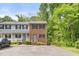 Exterior view of the townhome featuring brick, private parking and beautiful landscaping at 1903 Malone Rd # E, Burlington, NC 27215
