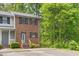 Charming brick townhome featuring black shutters, a cozy entrance, and well-kept landscaping at 1903 Malone Rd # E, Burlington, NC 27215