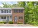 Charming brick townhouse with black shutters and a well-maintained front yard surrounded by lush trees at 1903 Malone Rd # E, Burlington, NC 27215