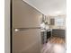 Modern kitchen featuring gray cabinets, stainless steel appliances, granite countertops, and wood-look flooring at 1903 Malone Rd # E, Burlington, NC 27215