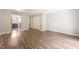 Inviting living room featuring wood flooring and neutral paint, flowing seamlessly into the kitchen at 1903 Malone Rd # E, Burlington, NC 27215