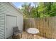 Back deck with a table, chair, and adjacent storage space offers an inviting outdoor space at 1903 Malone Rd # E, Burlington, NC 27215