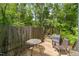 Back deck with a table, chair, and grill offers an inviting outdoor space for relaxation and entertainment at 1903 Malone Rd # E, Burlington, NC 27215