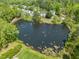 Aerial shot of a scenic neighborhood surrounding a calm lake and lush trees at 1911 Housatonic Ct, Apex, NC 27523