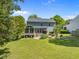 Exterior showing a home with screened-in porch, patio, and grassy backyard area at 1911 Housatonic Ct, Apex, NC 27523