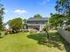 A well-maintained backyard features a stone patio with seating and screened-in porch at 1911 Housatonic Ct, Apex, NC 27523