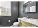 Bathroom featuring stylish vanity with decorative accents and updated mirror and toilet at 1911 Housatonic Ct, Apex, NC 27523