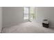 Bedroom featuring large windows and neutral carpeting, with printer at 1911 Housatonic Ct, Apex, NC 27523