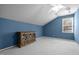 Bedroom featuring a blue wall, angled ceiling and a classic style cabinet with glass doors at 1911 Housatonic Ct, Apex, NC 27523
