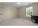 Cozy bedroom with a bright window, offering comfortable carpet and neutral walls at 1911 Housatonic Ct, Apex, NC 27523