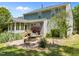 Exterior view showcasing a patio, sunroom and the backyard of this two-story home at 1911 Housatonic Ct, Apex, NC 27523