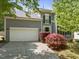 Charming two-story home with a well-manicured lawn, a spacious two-car garage, and elegant architectural details at 1911 Housatonic Ct, Apex, NC 27523