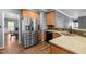 Modern kitchen with stainless steel appliances, granite countertops, and wooden cabinetry at 1911 Housatonic Ct, Apex, NC 27523