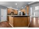 Kitchen with granite countertops, wood cabinets, stainless steel appliances, and ample lighting at 1911 Housatonic Ct, Apex, NC 27523