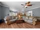 Spacious living room with open access to the kitchen, featuring comfortable leather sofas at 1911 Housatonic Ct, Apex, NC 27523
