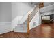 Carpeted stairway showcasing classic architectural details, hardwood flooring and cozy nearby living space at 1911 Housatonic Ct, Apex, NC 27523