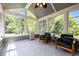 Bright sunroom filled with natural light and tile flooring with comfortable seating and view at 1911 Housatonic Ct, Apex, NC 27523