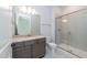 Stylish bathroom featuring granite counters, gray cabinets and a glass enclosed shower at 2 Deer Run Trl, Hillsborough, NC 27278