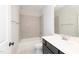 Bathroom featuring a shower-tub combo with neutral-toned backsplash tiles and a dark vanity at 2 Deer Run Trl, Hillsborough, NC 27278