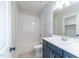 Bathroom featuring a shower-tub combo with a white subway tile backsplash and a dark vanity at 2 Deer Run Trl, Hillsborough, NC 27278