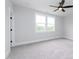Bedroom with carpeted floor, ceiling fan, and a double window allowing for natural light at 2 Deer Run Trl, Hillsborough, NC 27278