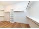 Walk-in closet with wooden floors, custom shelving, and ample storage space at 2 Deer Run Trl, Hillsborough, NC 27278