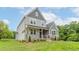 Charming home with stone accents, a covered front porch, and manicured landscaping at 2 Deer Run Trl, Hillsborough, NC 27278