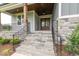 Inviting front porch with stone steps and elegant black railing details at 2 Deer Run Trl, Hillsborough, NC 27278
