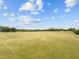 Picture of open grassy land under a beautiful sky with many trees and grass at 2 Deer Run Trl, Hillsborough, NC 27278