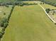 Beautiful acreage bordered by trees, complemented by a long driveway entrance to the property at 2 Deer Run Trl, Hillsborough, NC 27278