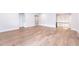 Bright living room with hardwood floors, natural light, and a staircase in the background at 2 Deer Run Trl, Hillsborough, NC 27278
