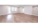 Bright living room featuring light hardwood floors and natural light from large windows at 2 Deer Run Trl, Hillsborough, NC 27278