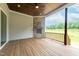Covered porch featuring a wood-burning fireplace and wood plank flooring, ideal for relaxing outdoors at 2 Deer Run Trl, Hillsborough, NC 27278