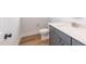 Modern powder room with sleek vanity and hardwood floors at 2 Deer Run Trl, Hillsborough, NC 27278