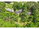 Aerial view showcases a house surrounded by trees and lush greenery on a large lot at 2008 Elizabeth Ct, Clayton, NC 27520