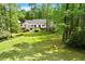 Home with landscaped backyard, mature trees, and expansive lawns at 2008 Elizabeth Ct, Clayton, NC 27520