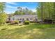 Home with landscaped backyard, mature trees, and expansive lawns at 2008 Elizabeth Ct, Clayton, NC 27520
