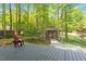 An outdoor wooden deck area and backyard with a gazebo surrounded by lush trees at 2008 Elizabeth Ct, Clayton, NC 27520