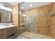 Bathroom featuring a glass-enclosed shower, vessel sink, and warm-toned tile at 2008 Elizabeth Ct, Clayton, NC 27520