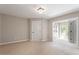 Bedroom featuring neutral walls, carpet, and a connecting room with large windows at 2008 Elizabeth Ct, Clayton, NC 27520