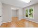 Bedroom with hardwood floors, a large window, and closet with mirrored doors at 2008 Elizabeth Ct, Clayton, NC 27520