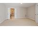 Neutral bedroom with an attached bathroom featuring a glass shower and double doors at 2008 Elizabeth Ct, Clayton, NC 27520