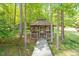 Tranquil wooden gazebo nestled among mature trees with walkway at 2008 Elizabeth Ct, Clayton, NC 27520