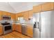 Beautiful kitchen featuring stainless steel appliances, granite countertops, and wooden cabinetry at 2008 Elizabeth Ct, Clayton, NC 27520