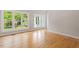 Bright living room with hardwood floors, big windows with nice backyard views, and neutral paint scheme at 2008 Elizabeth Ct, Clayton, NC 27520