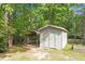 Outdoor storage shed with adjacent covered parking on a wooded lot at 2008 Elizabeth Ct, Clayton, NC 27520