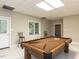 Spacious basement recreation room features a pool table, neutral walls, and an exterior entrance at 204 Highlands Lake Dr. Dr, Cary, NC 27518